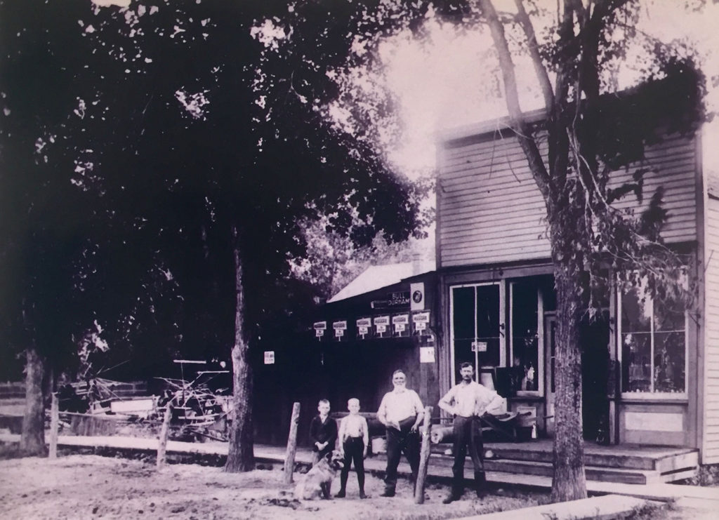 Black Jim (right) outside the Post Office and store he ran in Claremont, Minnesota